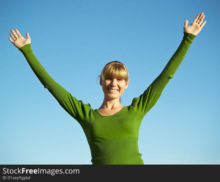 Portrait of the young woman posing on a background of the dark blue sky. Portrait of the young woman posing on a background of the dark blue sky