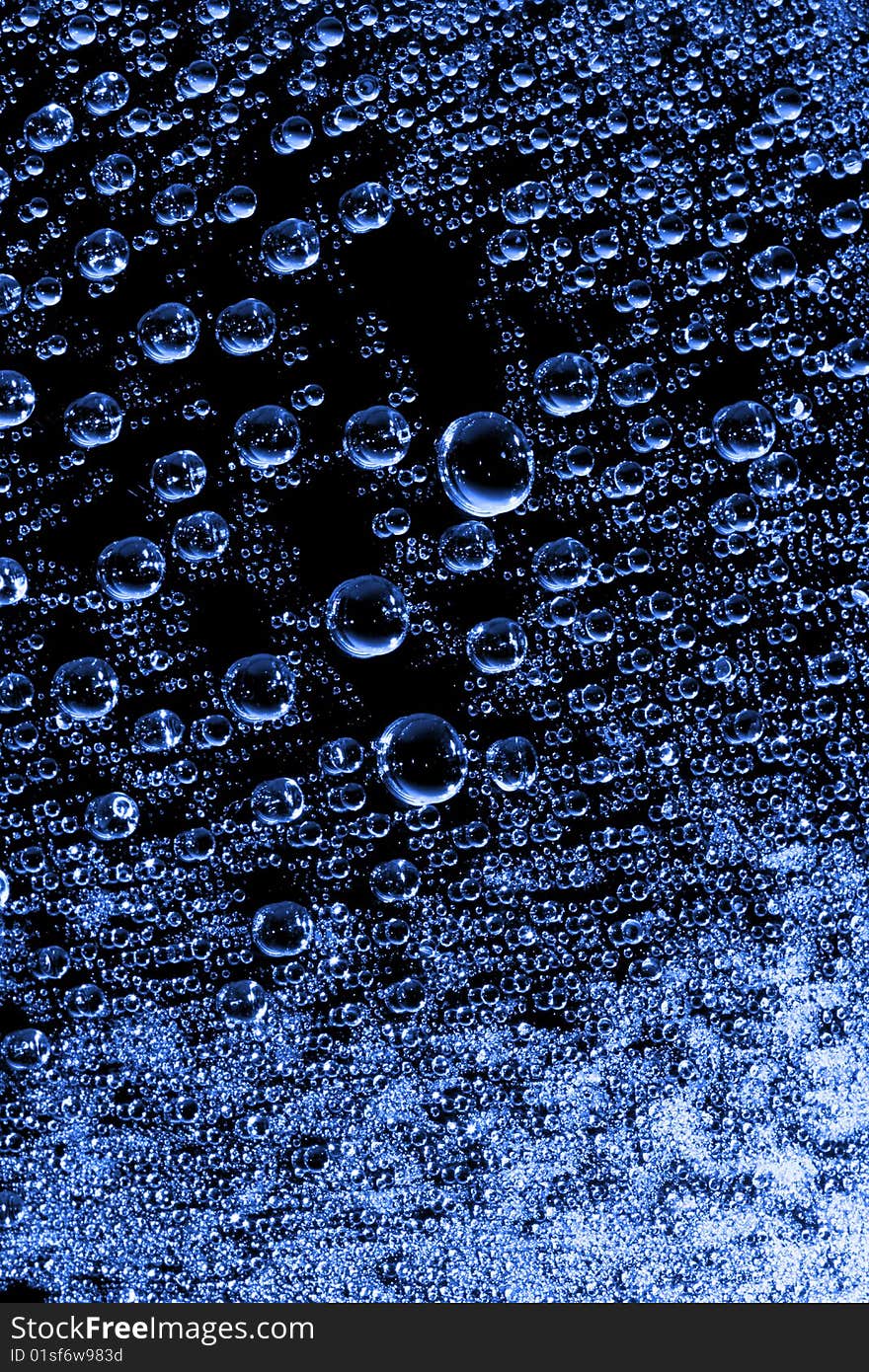 Blue water drops against black background