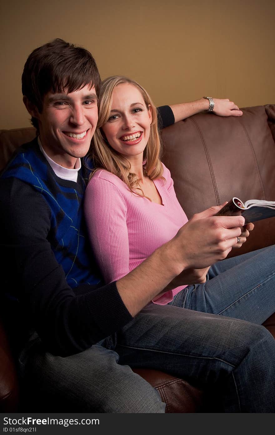 A happy couple relaxes at home on the couch. A happy couple relaxes at home on the couch