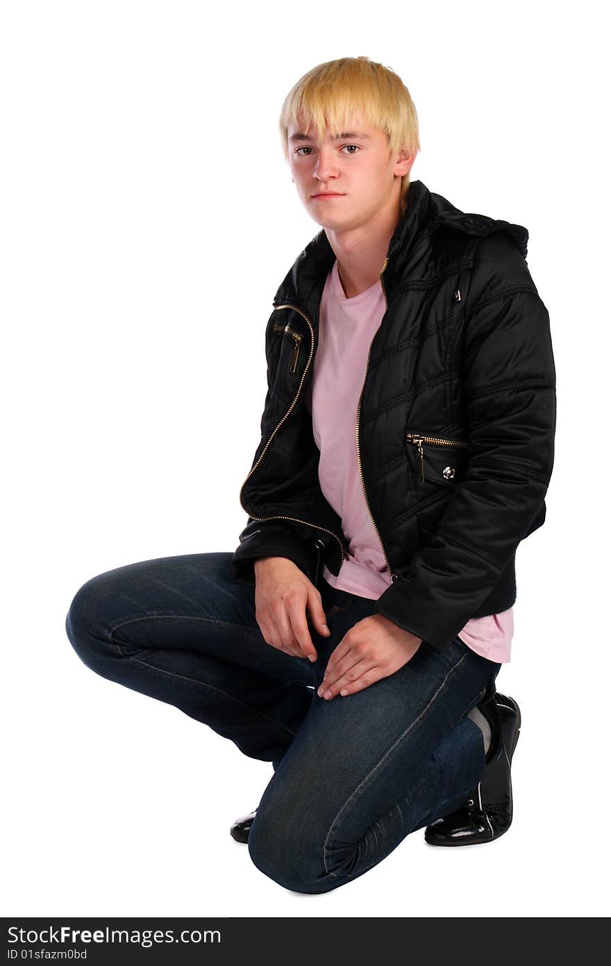 Young man in jacket sits. Isolated