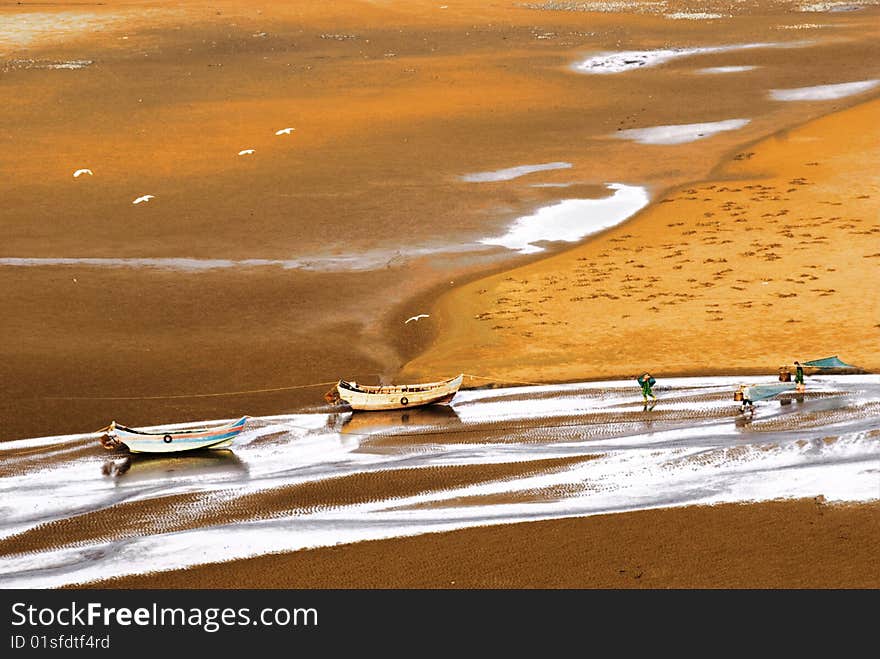 Boat on yellow beach in summer