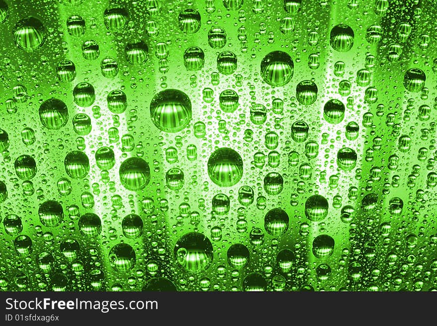 Water drops against green background. Water drops against green background