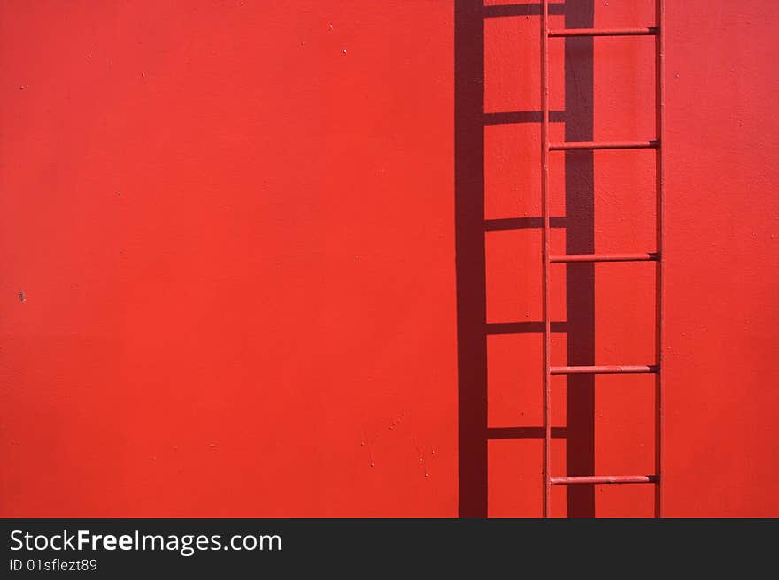 Fixed red ladder with copy space. Detail from a ship. Ladder in focus.