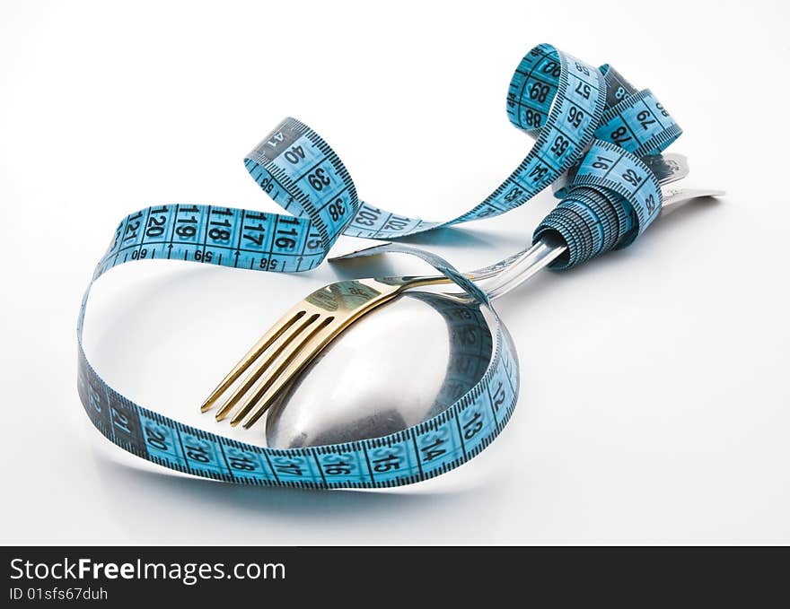 Cutlery with a measuring tape, diet, moderate eating. Cutlery with a measuring tape, diet, moderate eating