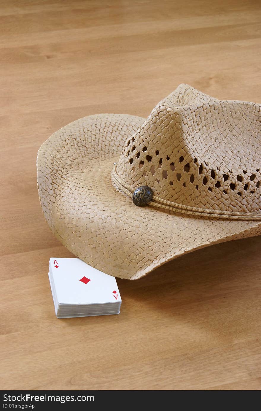 A deck of cards and a hat are holding the table for the comming players. A deck of cards and a hat are holding the table for the comming players.