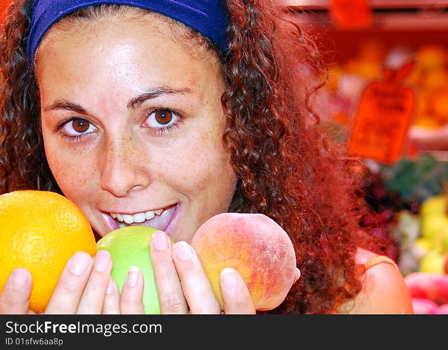 Close up of woman in a fruit market holding fruit in her hands. Close up of woman in a fruit market holding fruit in her hands