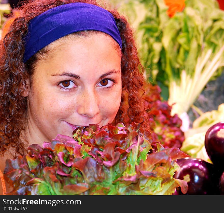 Close up of woman standing behind salad and eggplants. Close up of woman standing behind salad and eggplants