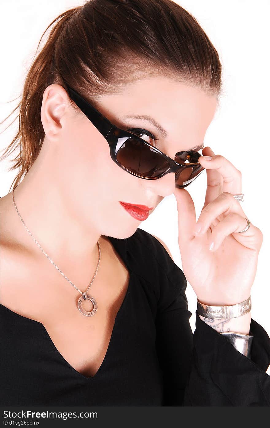 Elegant lady looking over her sunglasses and wearing a black dress
for white background in the studio. Elegant lady looking over her sunglasses and wearing a black dress
for white background in the studio.