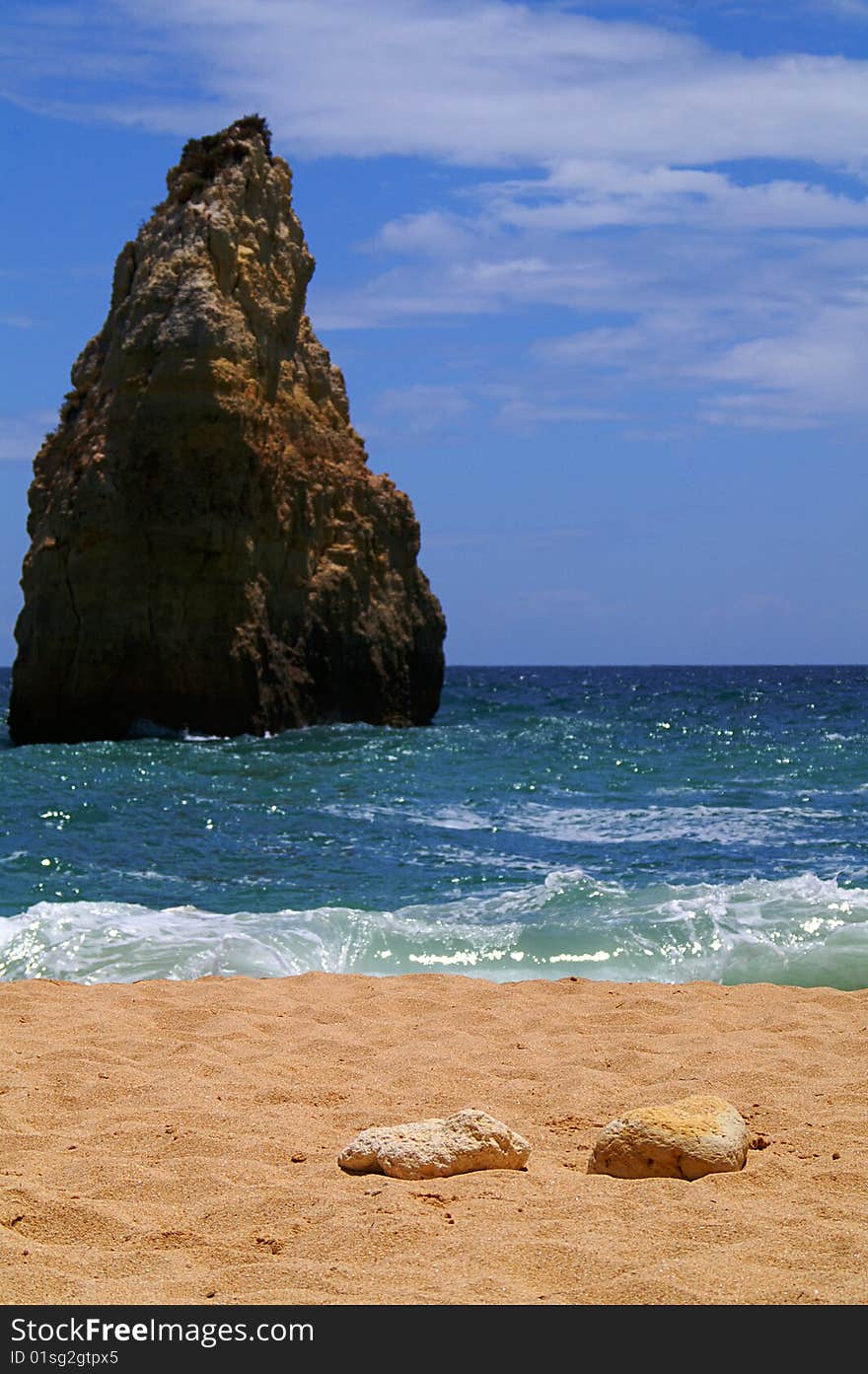 Rock formation in the water in front of a beach