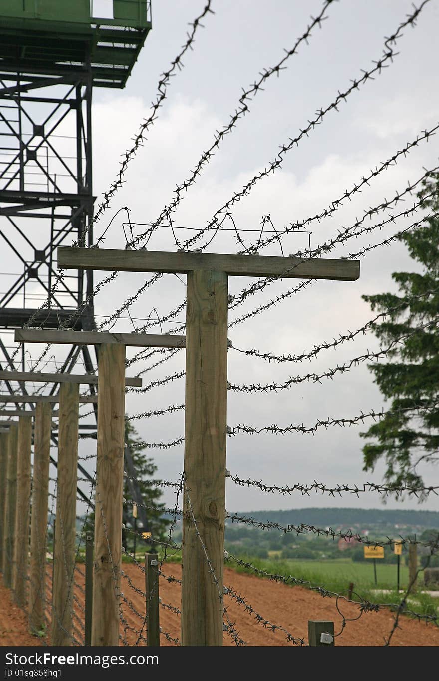 Barbed wire fence with clouds in background - frontier protection. Barbed wire fence with clouds in background - frontier protection