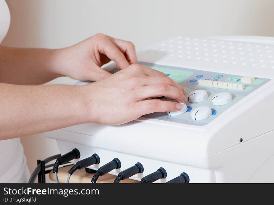 Hands of masseur on massage device