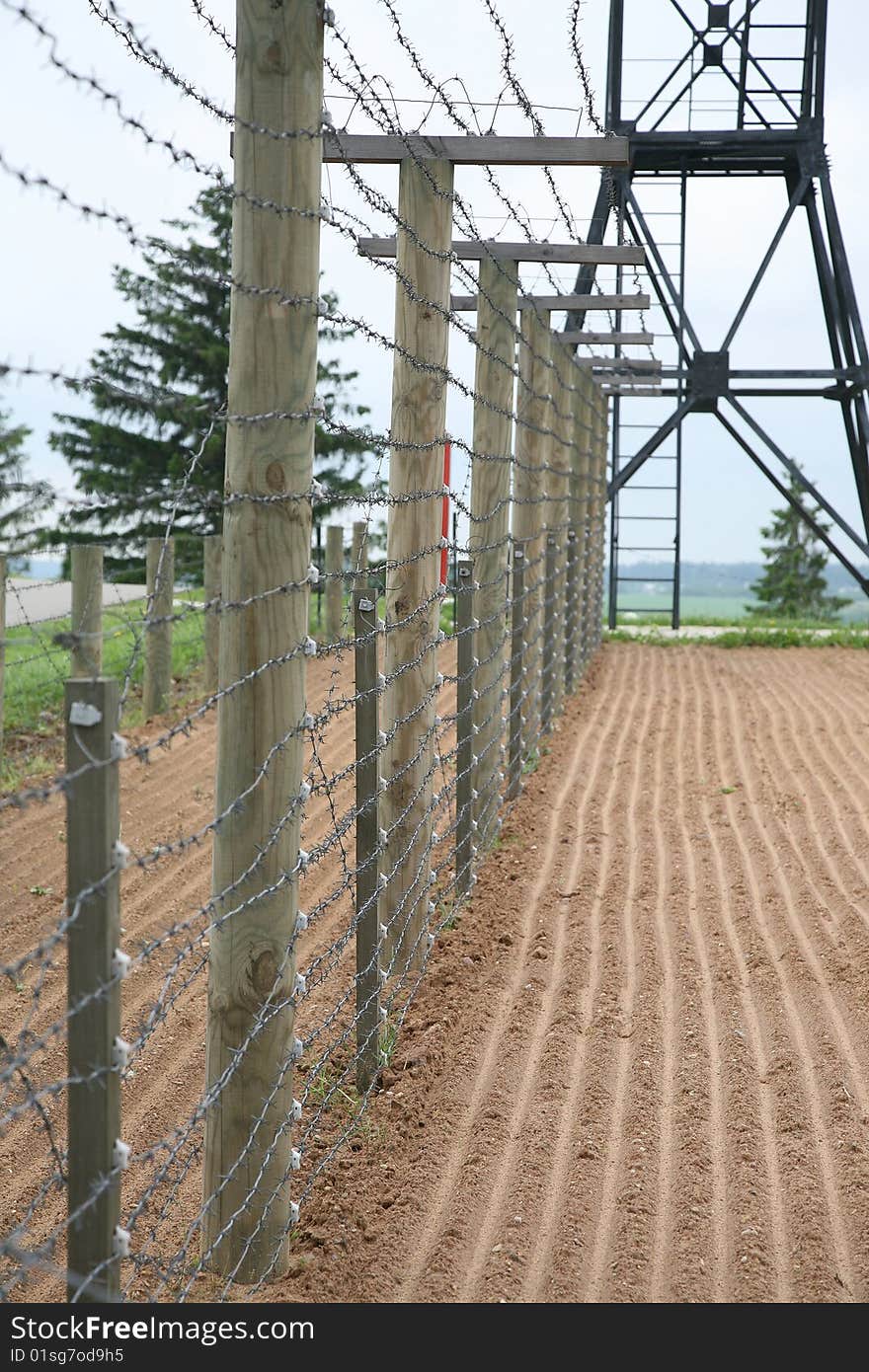 Barbed wire fence with clouds in background - frontier protection. Barbed wire fence with clouds in background - frontier protection