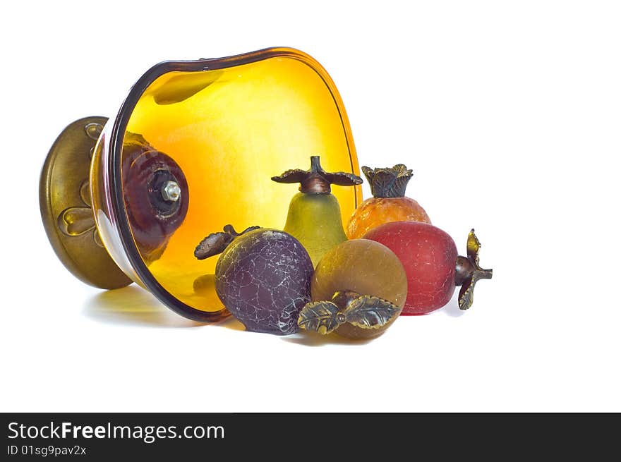 Glass bowl full of glass fruit spilling out of bowl. Glass bowl full of glass fruit spilling out of bowl