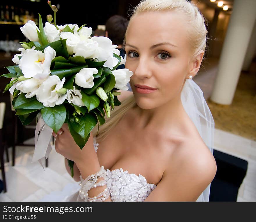 Young bride looking down with bouquet. Young bride looking down with bouquet