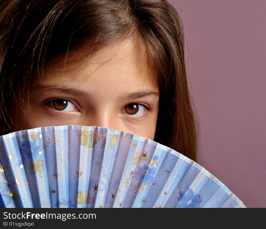 Portrait of young girl with fan.