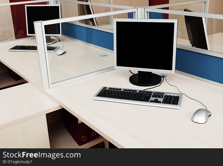 Computers behind the glass in a modern office