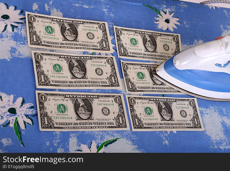 Woman ironing dollars on a board