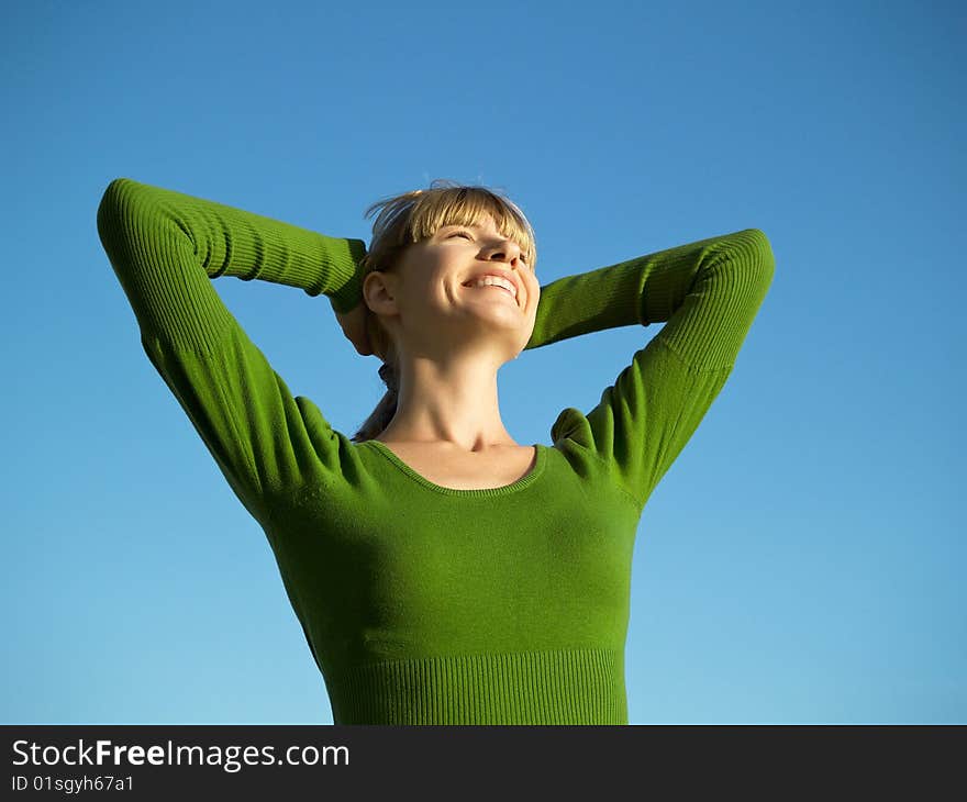 Portrait of the young woman posing on a background of the dark blue sky. Portrait of the young woman posing on a background of the dark blue sky