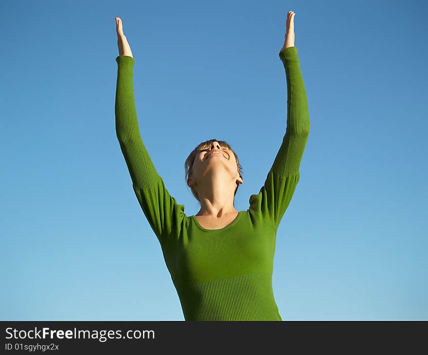 Portrait of the young woman posing on a background of the dark blue sky. Portrait of the young woman posing on a background of the dark blue sky