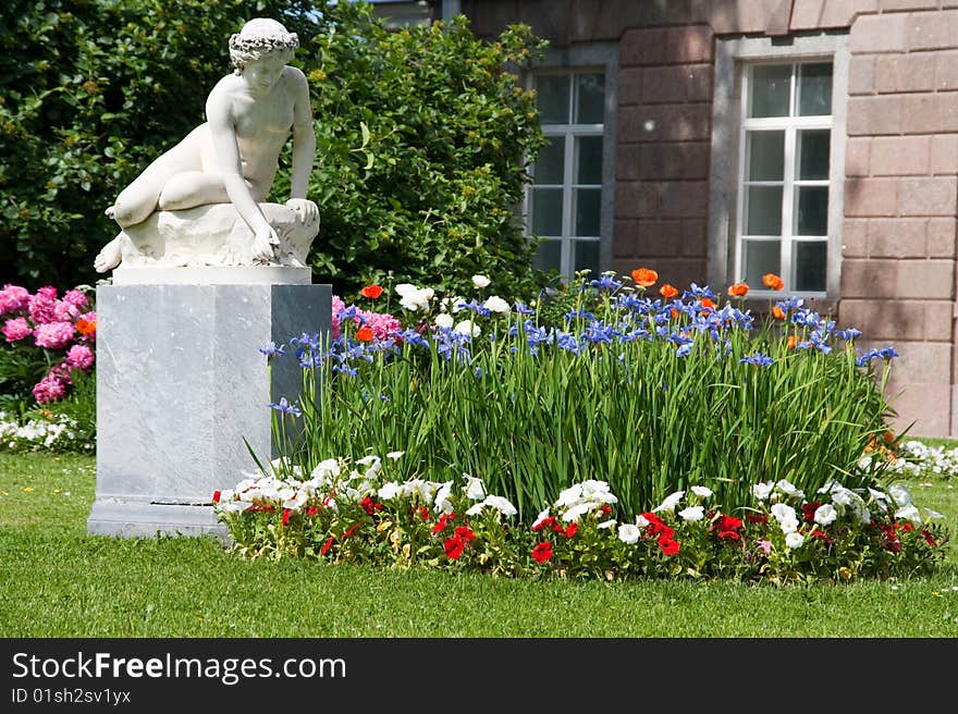 Statue of a girl in a summer garden