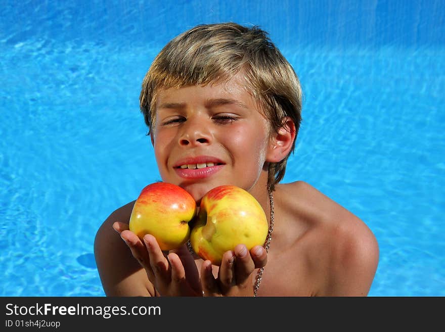 Boy presenting apples in the summer sun