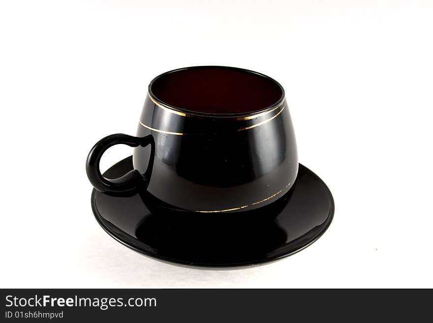 Blackenning cup with saucer on white background