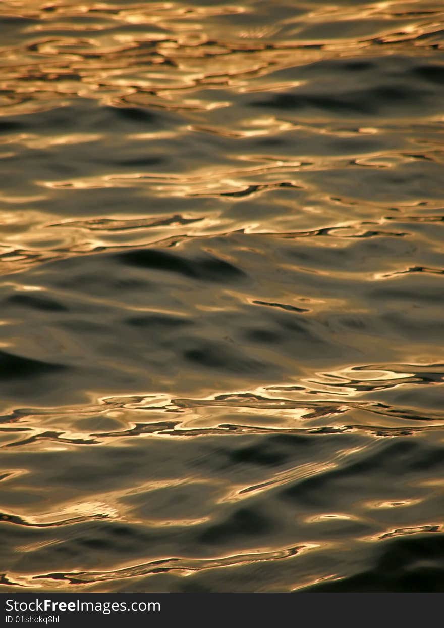 Beautiful reflection of sun light in the sunset on Adriatic sea. Vertical color photo. . Beautiful reflection of sun light in the sunset on Adriatic sea. Vertical color photo.