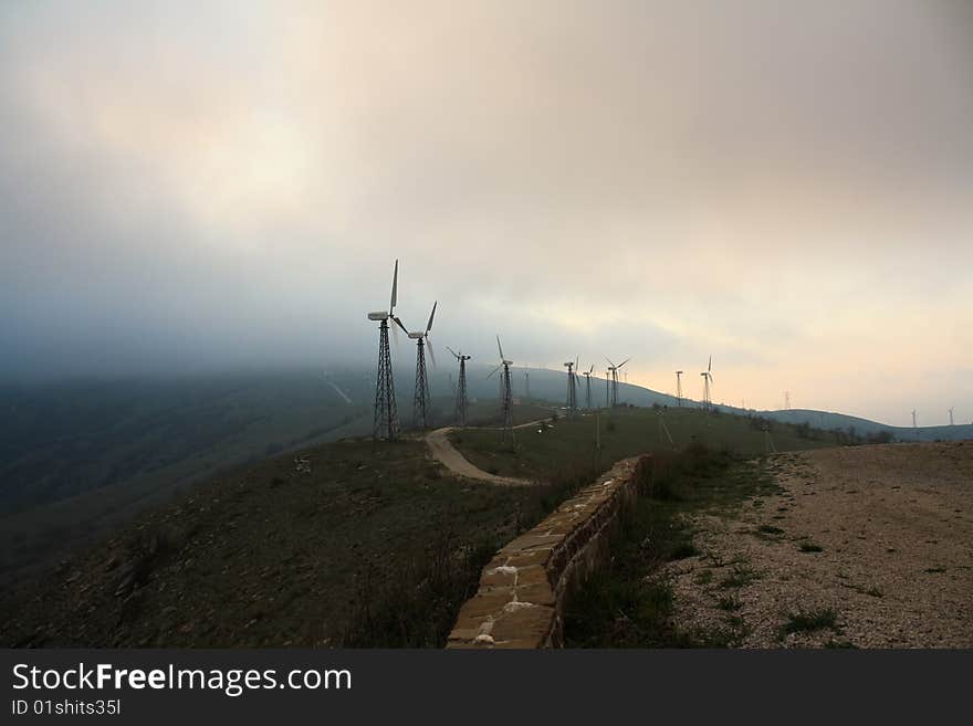 The windmills high in the mountains are producing electricity