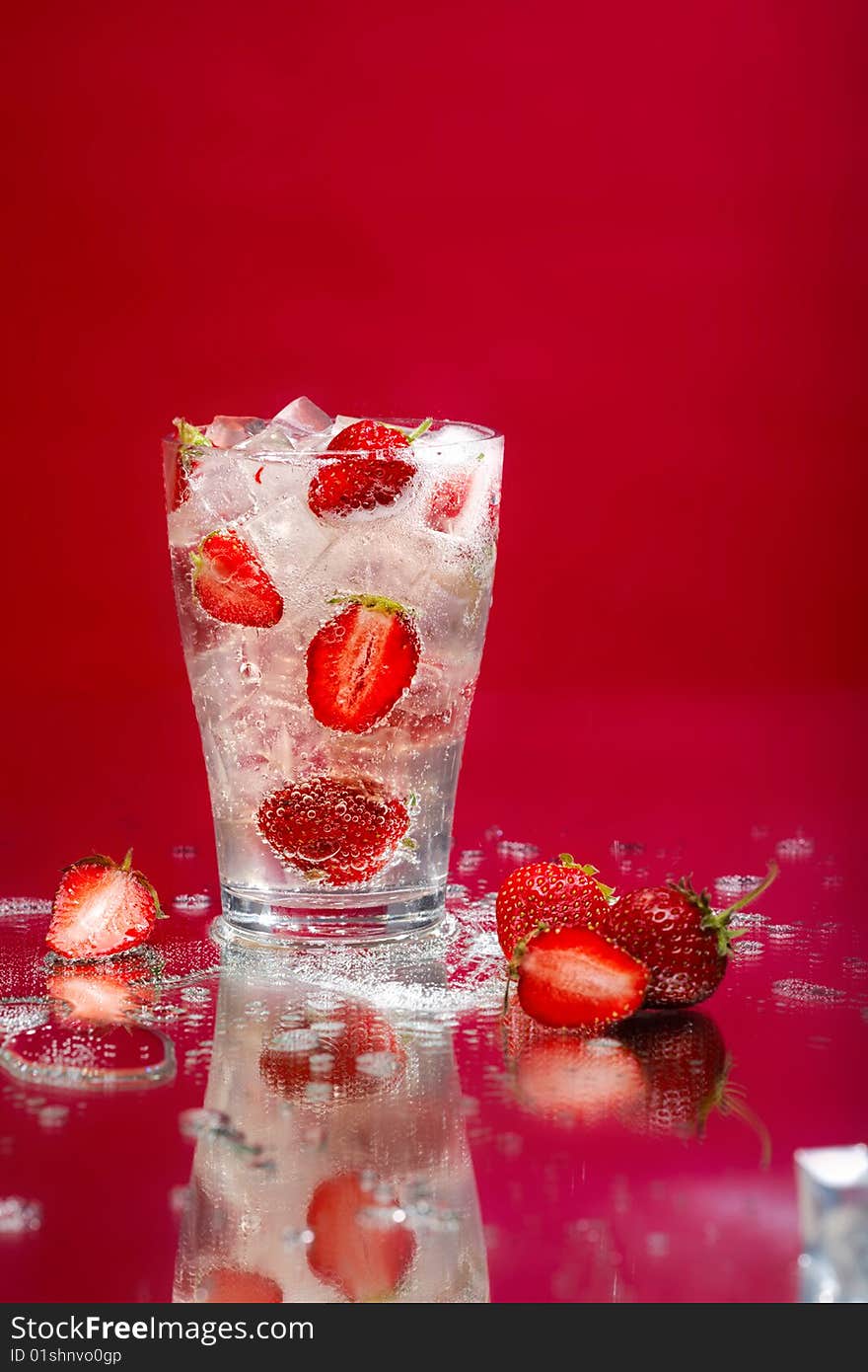 Juicy strawberry in a glass with ice. Juicy strawberry in a glass with ice