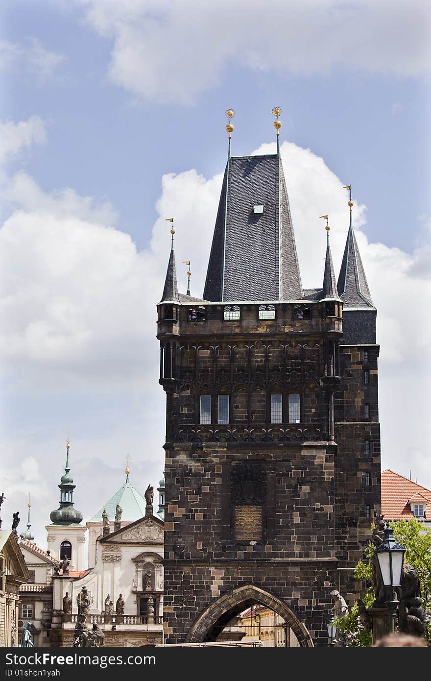 Charles bridge tower over old city facades.