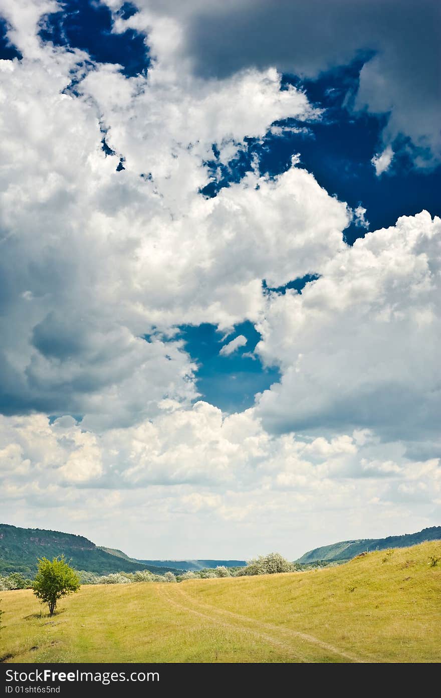 Rural landscape with blue sky and clouds on it