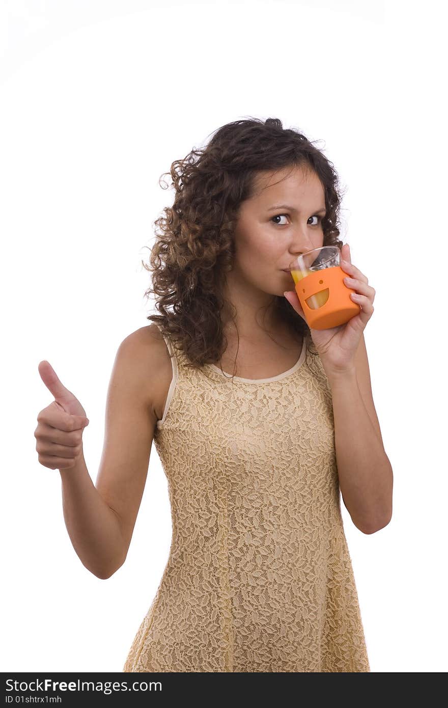 Woman is drinking orange juice and showing OK.