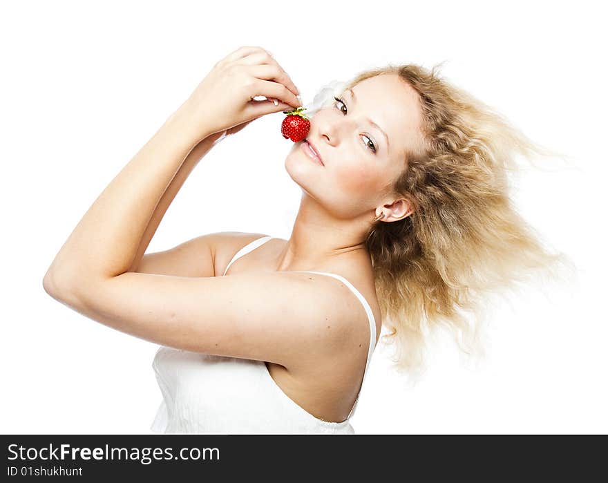 Young woman in white dress eating strawberries. Isolated on white background