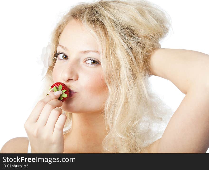 Young woman in white dress eating strawberries