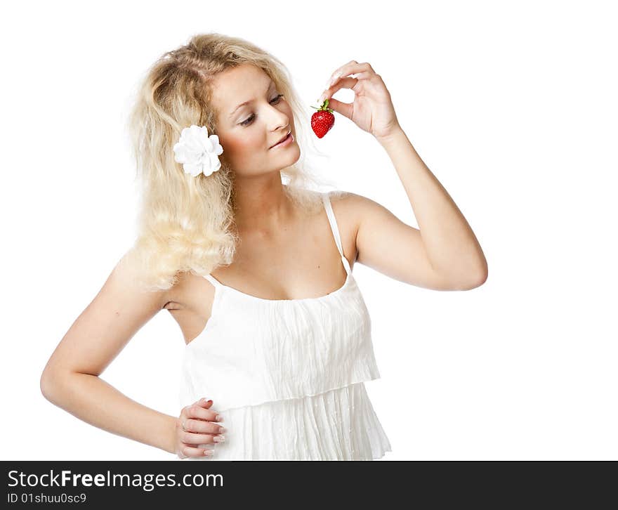 Young woman in white dress eating strawberries