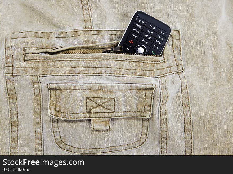 Cellphone stuffed in khaki jeans