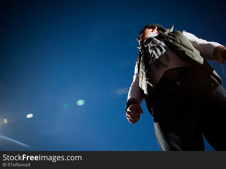 Young fashion model in jeans shot outdoors on a blue sky