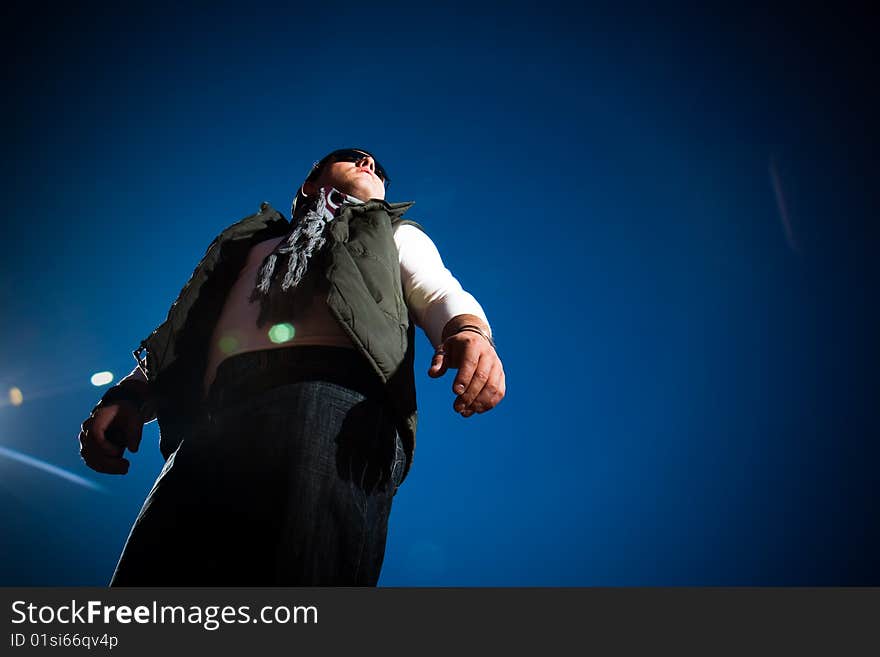 Young fashion model in jeans shot outdoors on a blue sky