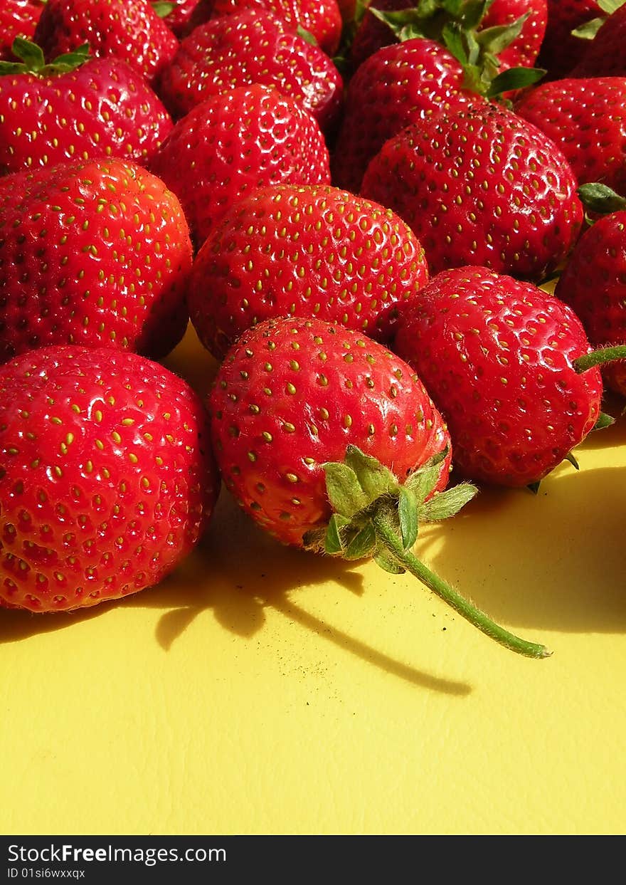 Fresh Strawberries on the yellow background