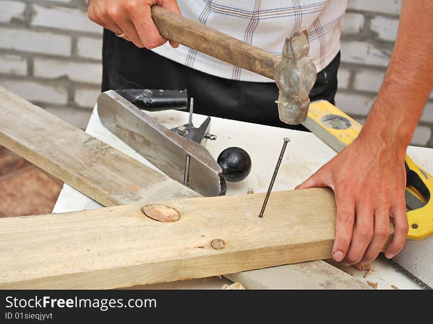 Hammer pounding nail close-up