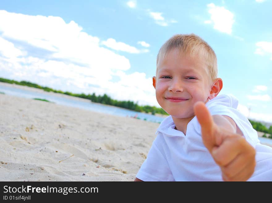 Little boy showing thumbs up sign