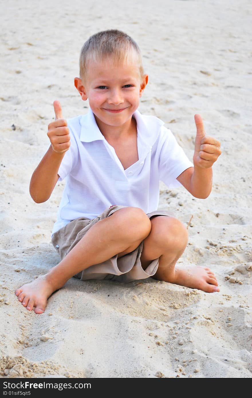 Little boy showing thumbs up sign