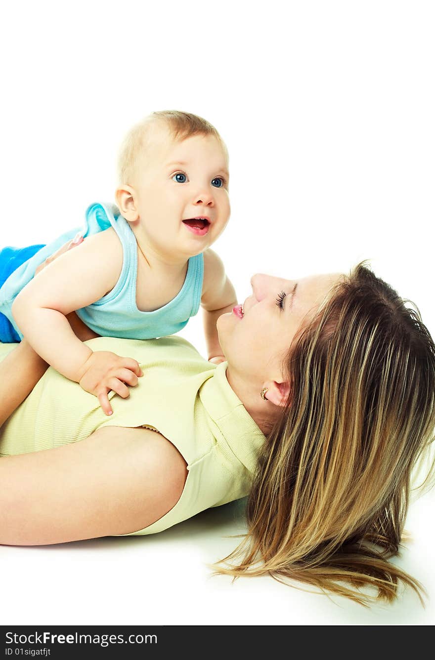 Happy young laughing mother with her baby on the floor. Happy young laughing mother with her baby on the floor