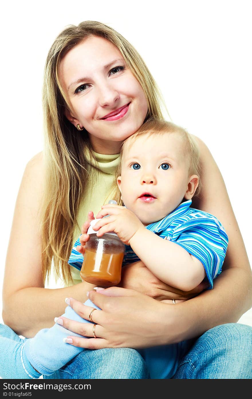 Happy young mother with her baby drinking juice. Happy young mother with her baby drinking juice