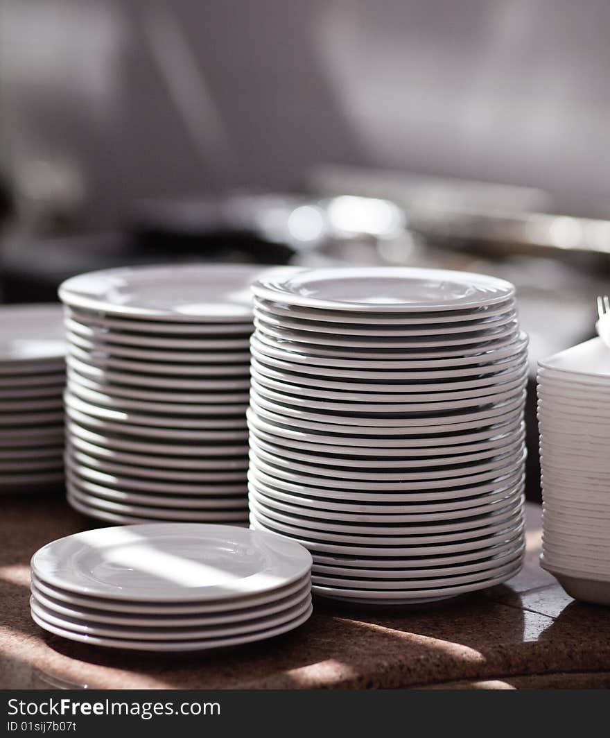 Piles of white pure plates on a table