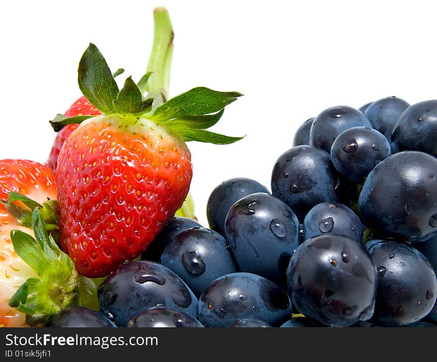 Fresh ripe strawberries and grapes isolated on white background. Fresh ripe strawberries and grapes isolated on white background