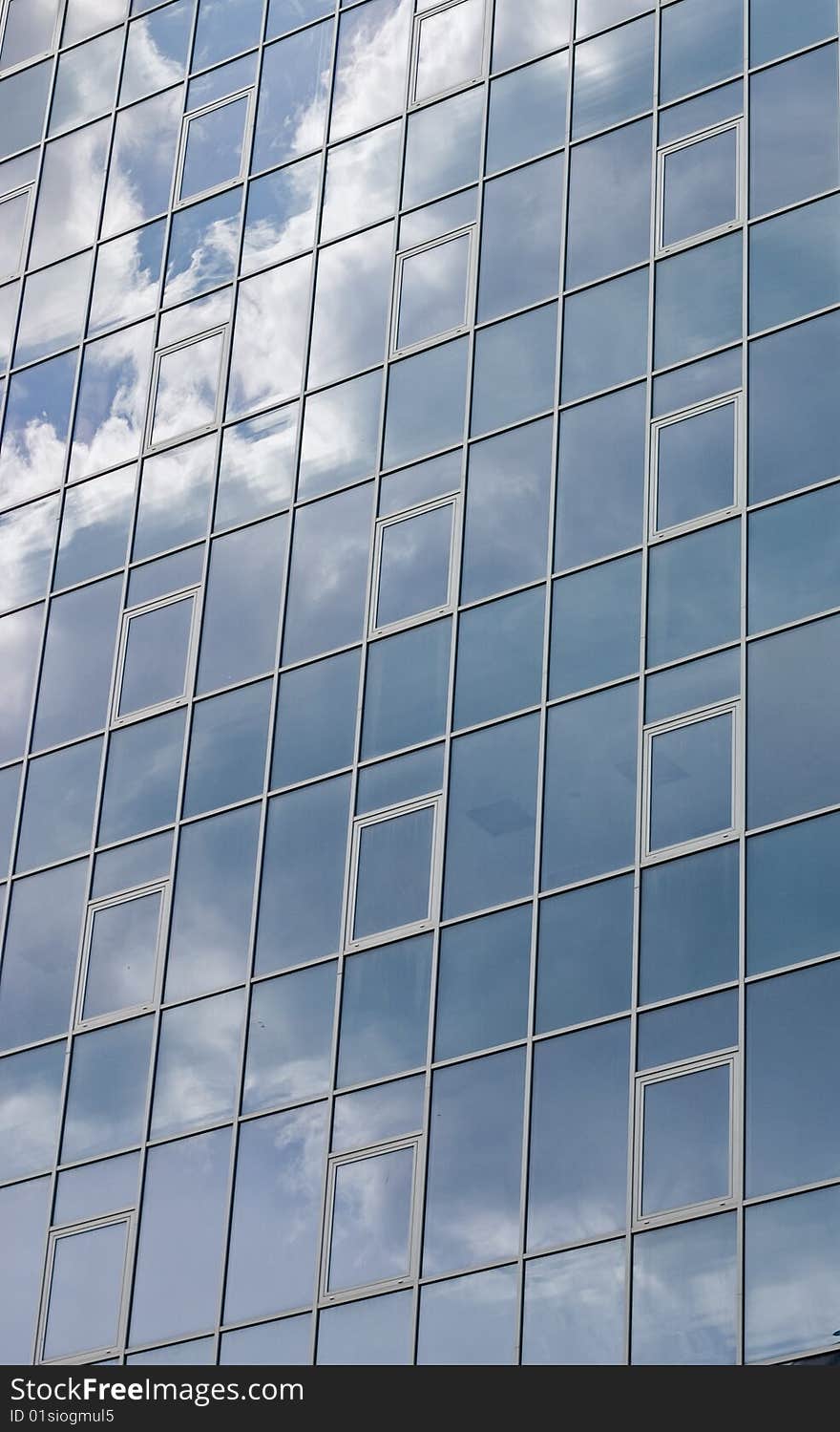 Mirror image of Clouds reflected on windows of building