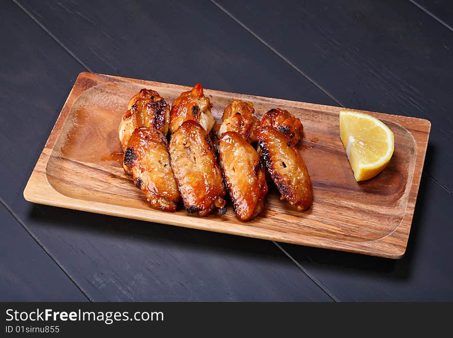 Grilled chicken wings served on wooden board