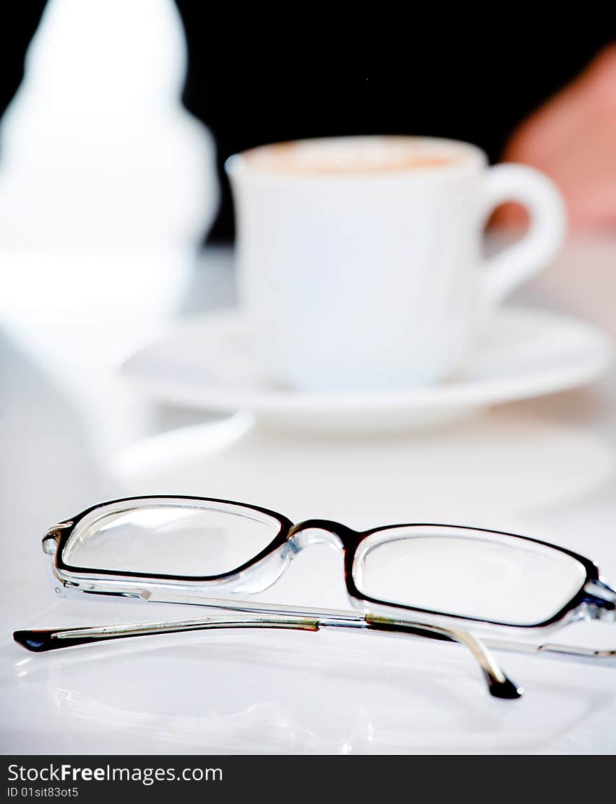 Glasses lying by a cup