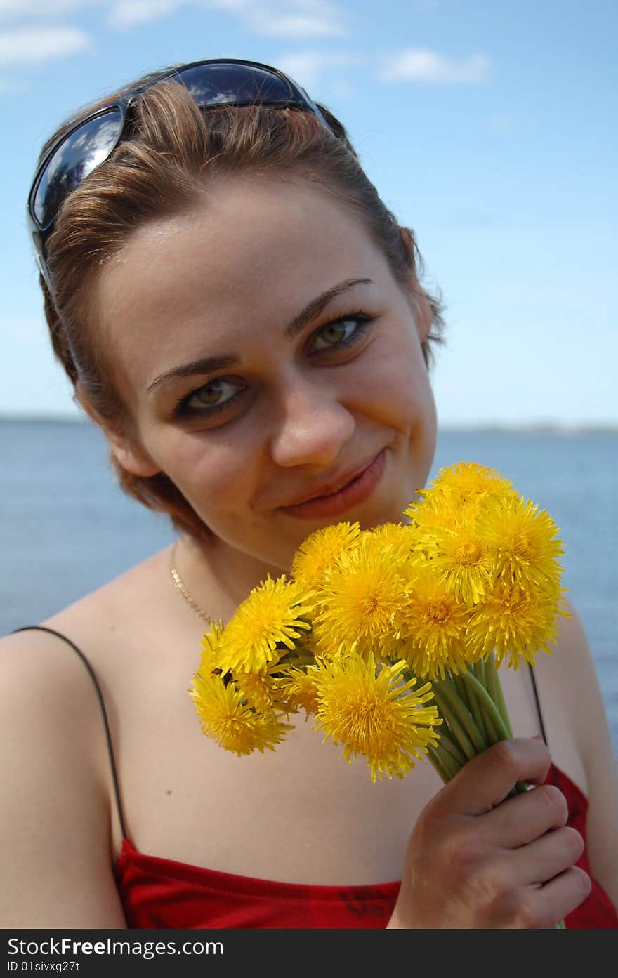 Girl holding yellow flowers